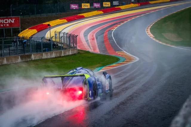 A Ligier JS P4 through Eau Rouge on a wet Spa-Francorchamps